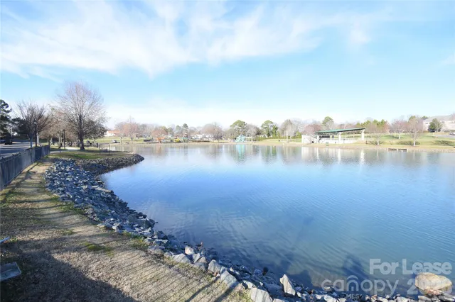 a view of a lake with houses in the back