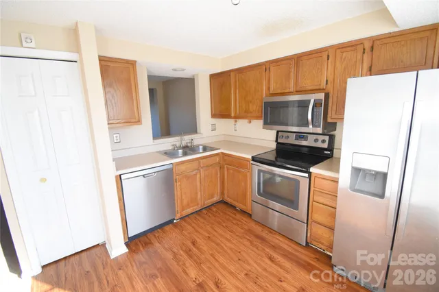 a kitchen with a refrigerator sink and microwave