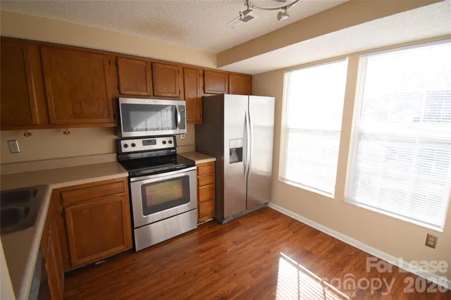 a kitchen with a refrigerator stove and microwave