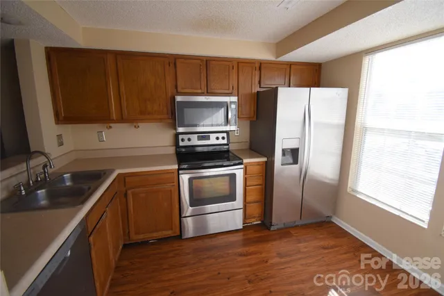 a kitchen with a refrigerator sink and microwave