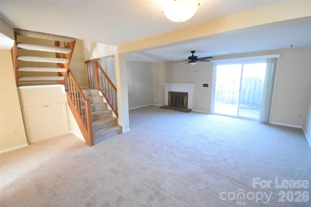 a view of an empty room with a fireplace