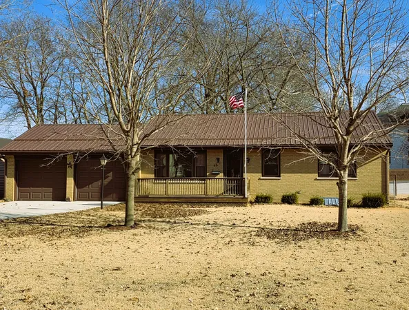 a front view of a house with a yard covered in snow