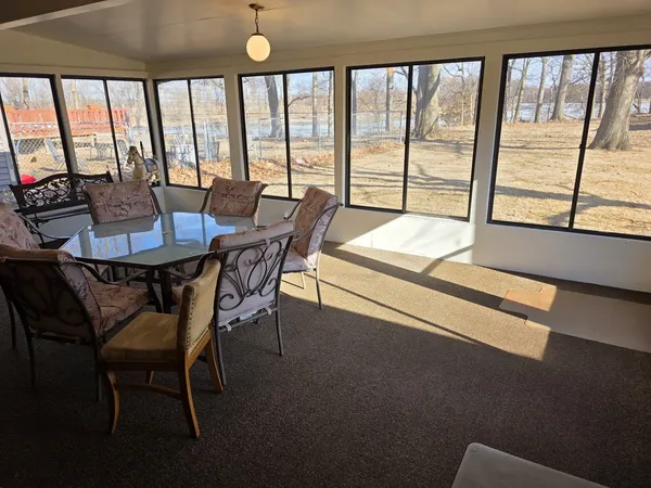 a view of a dining room with furniture and a window