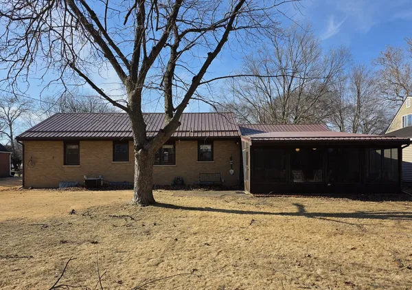 a house that has a tree in front of it