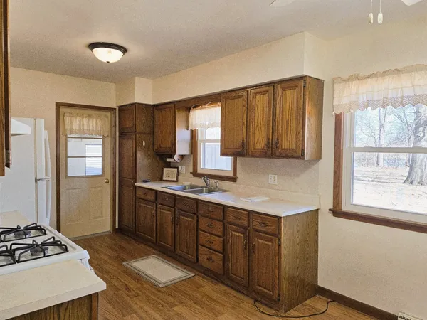 a kitchen with a sink cabinets and window