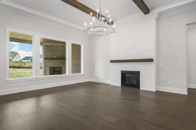 a kitchen with kitchen island white cabinets and refrigerator