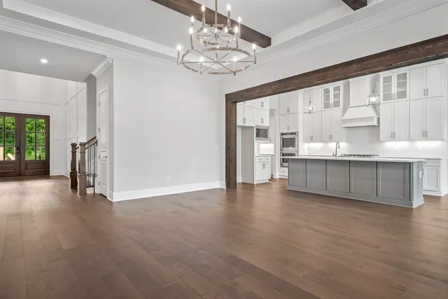 a large kitchen with kitchen island white cabinets and stainless steel appliances