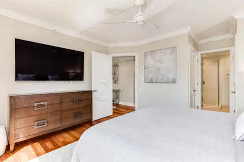 a bedroom with a bed and a flat screen tv