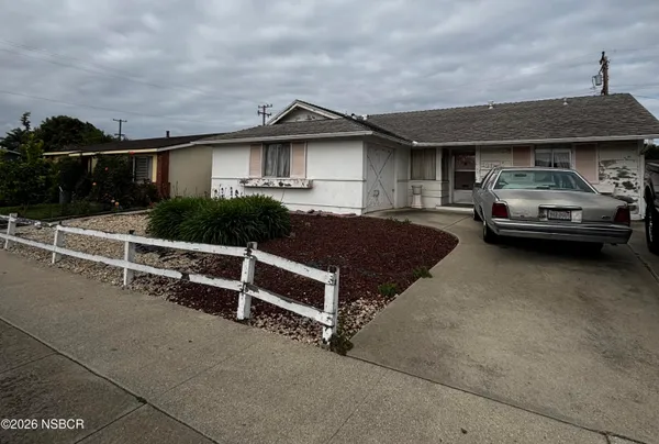 a front view of a house with parking space