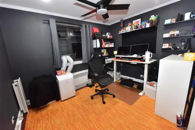 a work room with furniture a chandelier and a flat screen tv