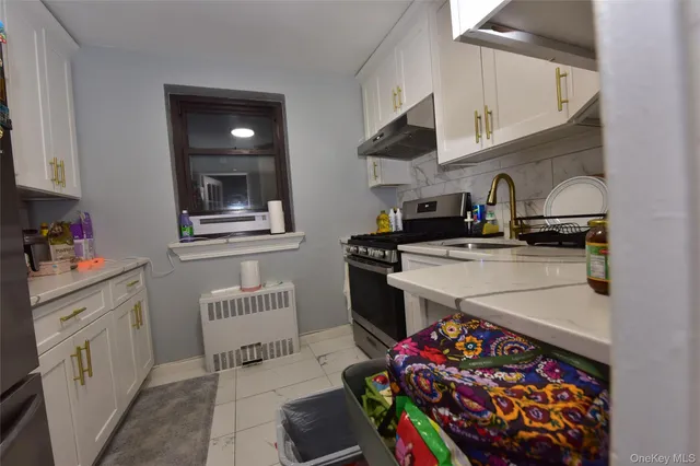 a kitchen with stainless steel appliances granite countertop a sink stove and cabinets