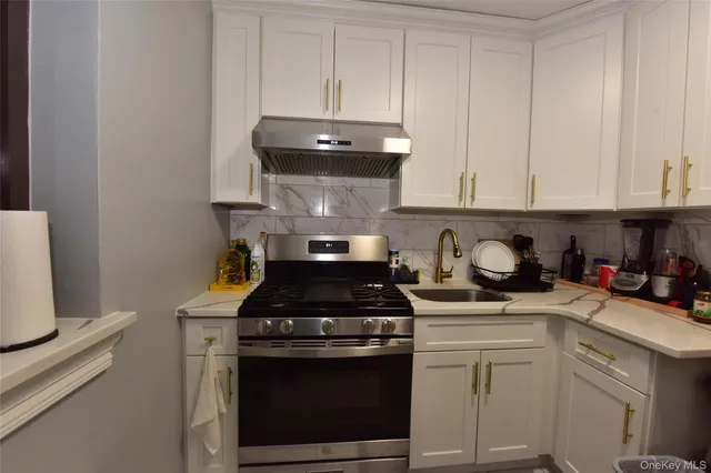 a kitchen with a stove and cabinets