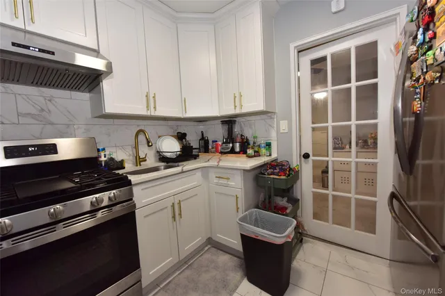a kitchen with a stove and white cabinets