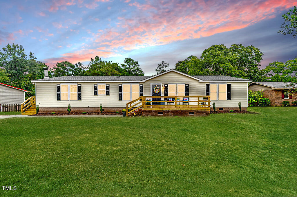 a view of a house with a backyard and a patio
