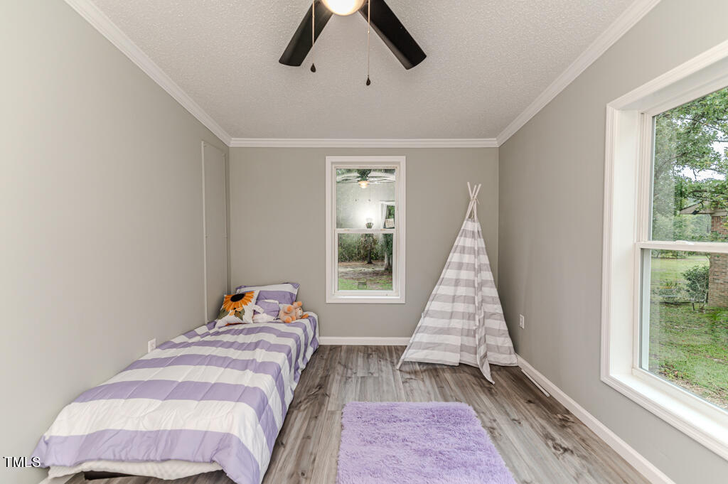 2245 Docs Road Lillington, NC 27546 - Photo 19 of 54 a bedroom with a bed and wooden floor