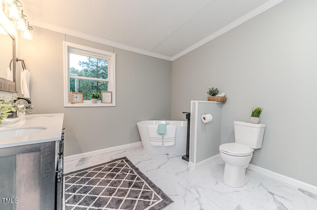 2245 Docs Road Lillington, NC 27546 - Photo 25 of 54 a bathroom with a toilet and a sink