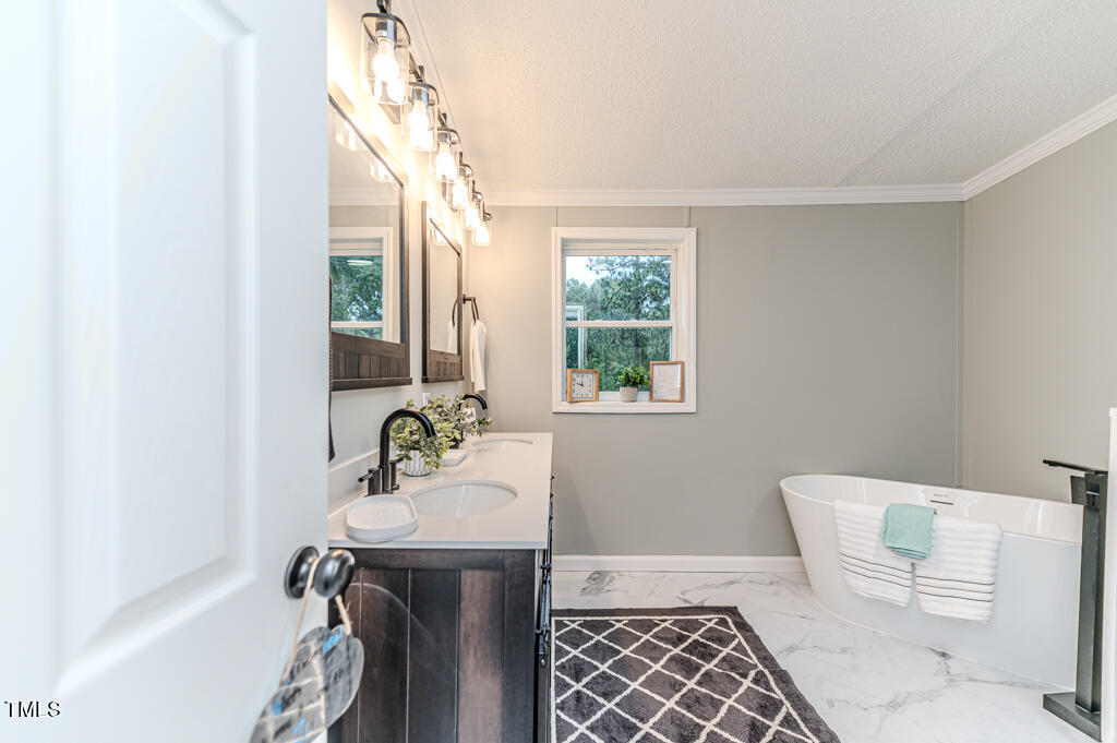 2245 Docs Road Lillington, NC 27546 - Photo 26 of 54 a bathroom with a sink and a mirror