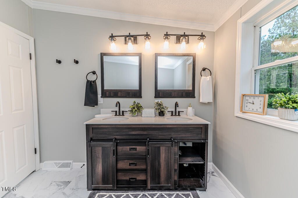 2245 Docs Road Lillington, NC 27546 - Photo 27 of 54 a bathroom with double sink and a mirror
