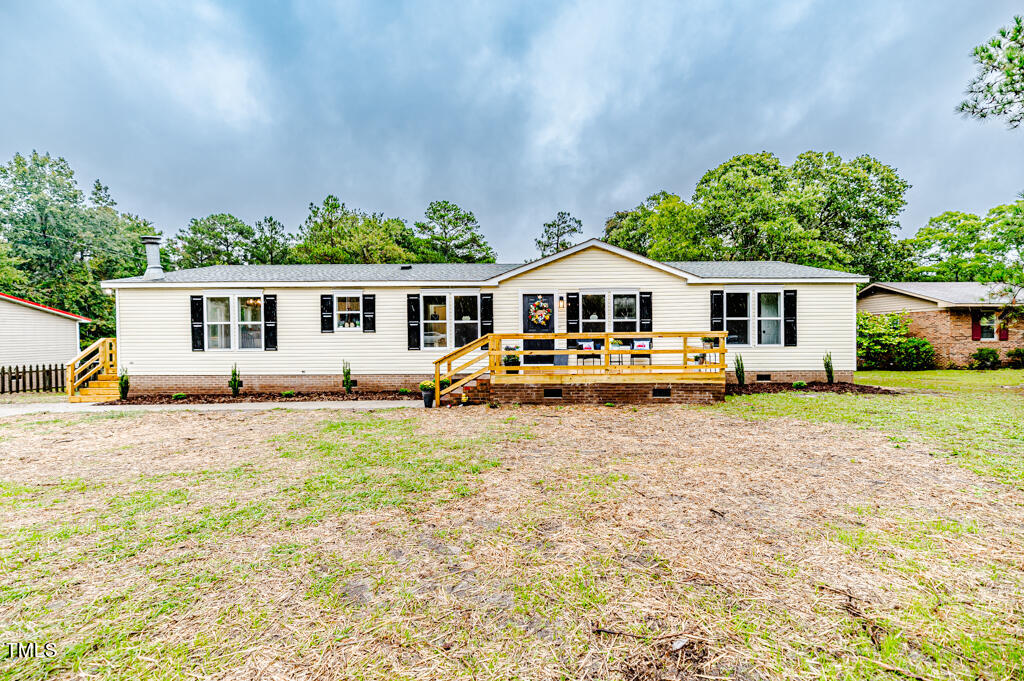 2245 Docs Road Lillington, NC 27546 - Photo 3 of 54 a view of house with garden and tall trees