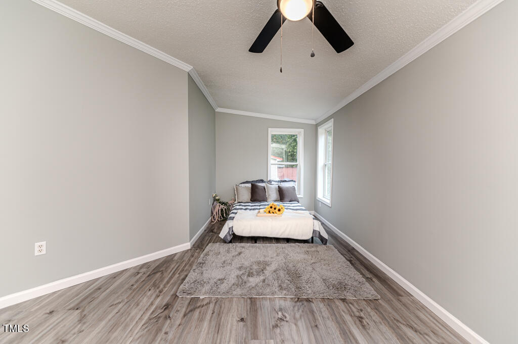 2245 Docs Road Lillington, NC 27546 - Photo 32 of 54 a bedroom with a bed and wooden floor