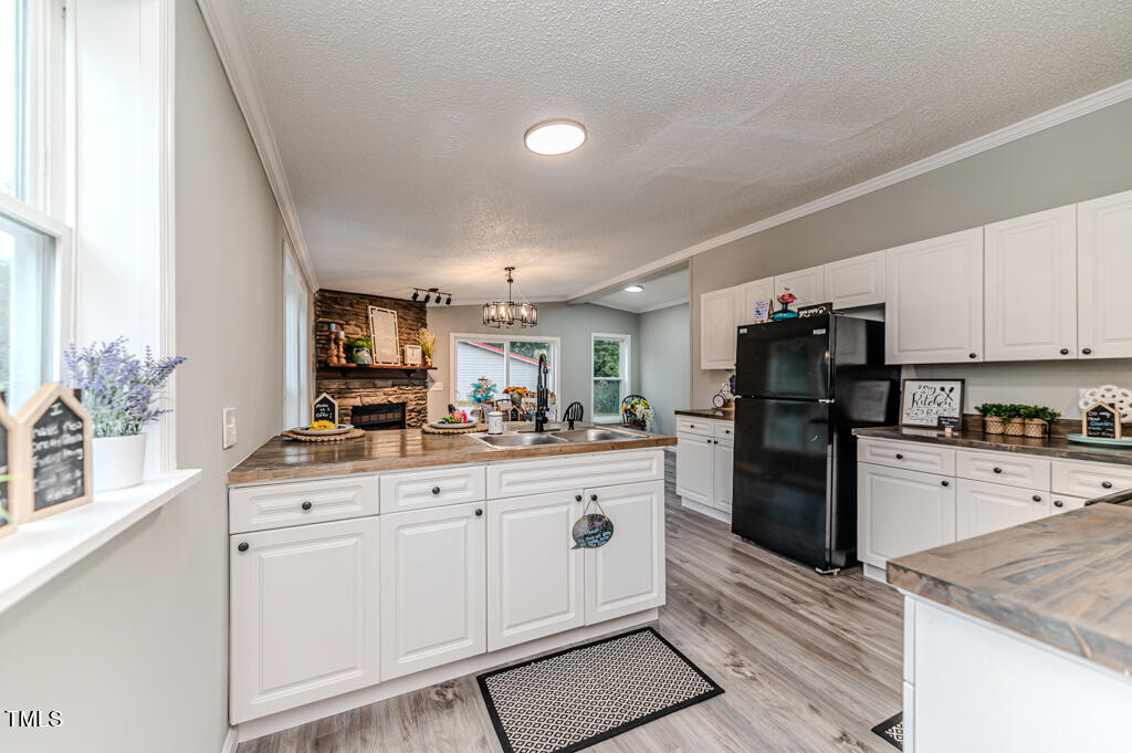 2245 Docs Road Lillington, NC 27546 - Photo 34 of 54 a kitchen with white cabinets and stainless steel appliances