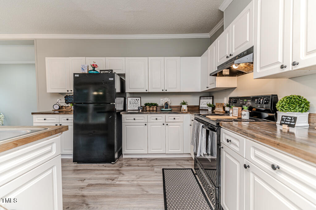 2245 Docs Road Lillington, NC 27546 - Photo 37 of 54 a kitchen with a refrigerator and a stove top oven