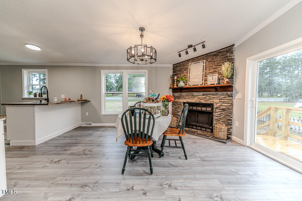 2245 Docs Road Lillington, NC 27546 - Photo 46 of 54 a view of a dining room with furniture a chandelier and wooden floor