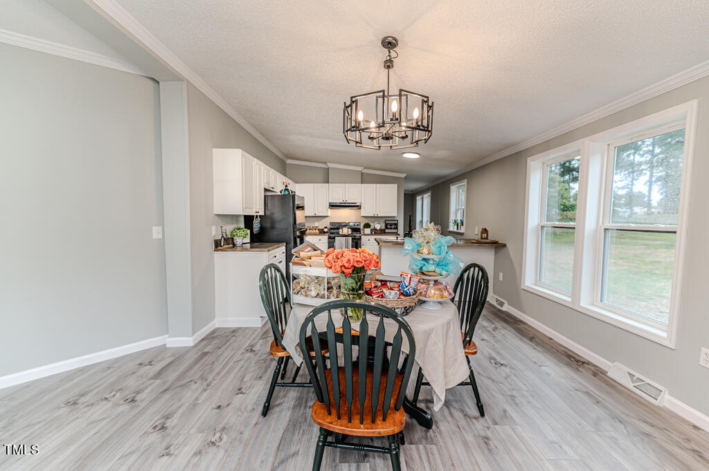 2245 Docs Road Lillington, NC 27546 - Photo 48 of 54 a view of a dining room with furniture window and wooden floor