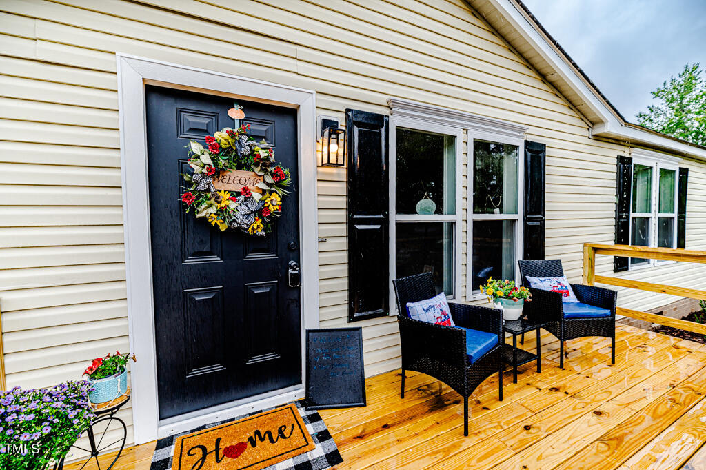 2245 Docs Road Lillington, NC 27546 - Photo 5 of 54 a outdoor living space with furniture and a potted plant