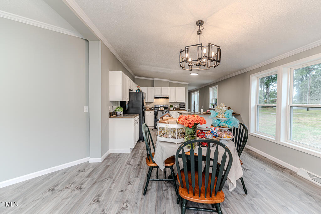 2245 Docs Road Lillington, NC 27546 - Photo 53 of 54 a view of a dining room with furniture window and wooden floor