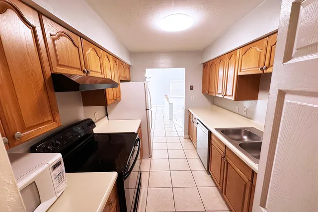 a kitchen with stainless steel appliances a stove a sink and a refrigerator