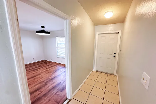 a view of an empty room and wooden floor