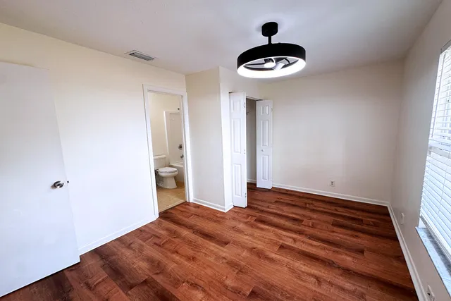 wooden floor in an empty room with a window