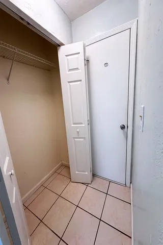 a view of a utility room with closet