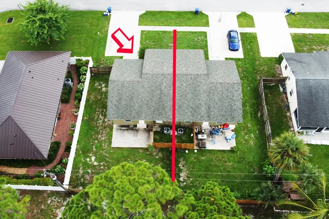 an aerial view of a houses with street
