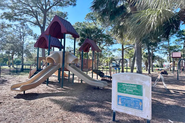 a view of a park with swings and slides