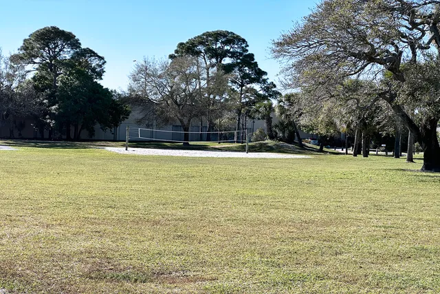 an aerial view of residential houses with outdoor space and lake view