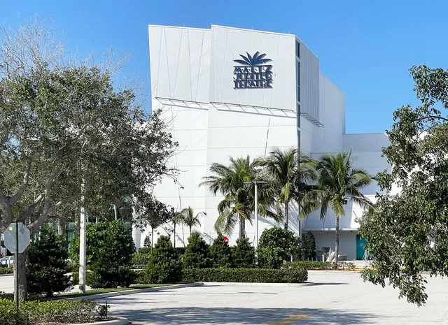 a view of a park with swings and sign board