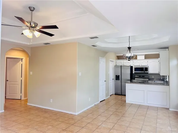 a kitchen with stainless steel appliances a stove a refrigerator and a sink