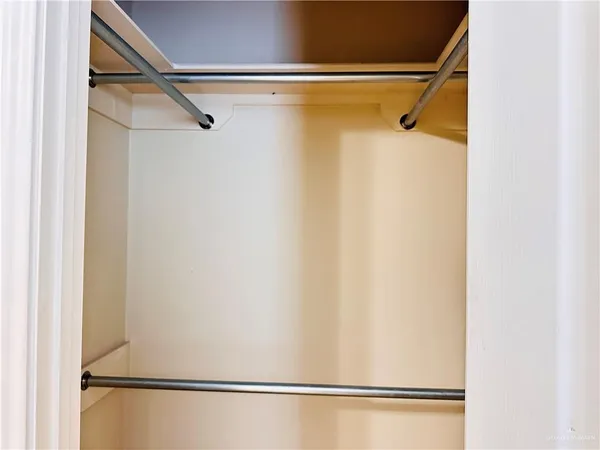 a view of walk in closet with clothes