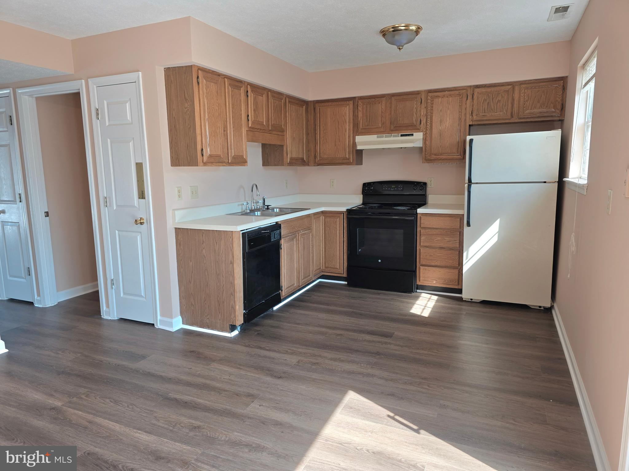 80 Stadium Circle Inwood, WV 25428 - Photo 28 of 53 a kitchen with a refrigerator sink and wooden floor