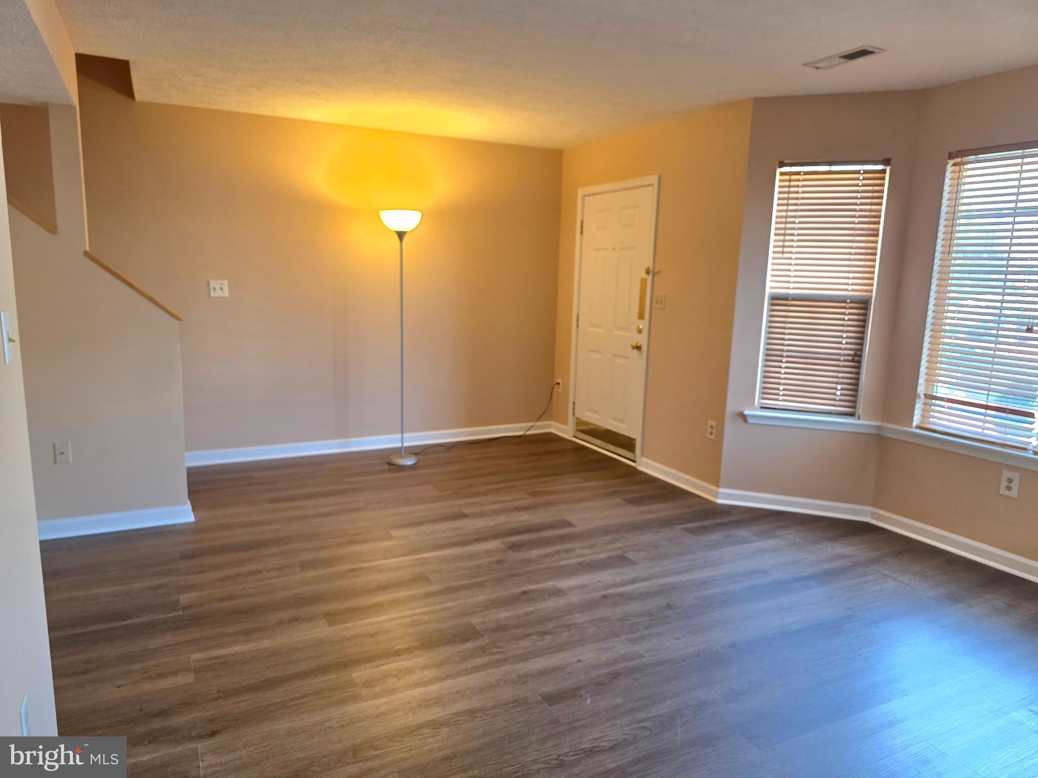 80 Stadium Circle Inwood, WV 25428 - Photo 8 of 53 an empty room with wooden floor and windows