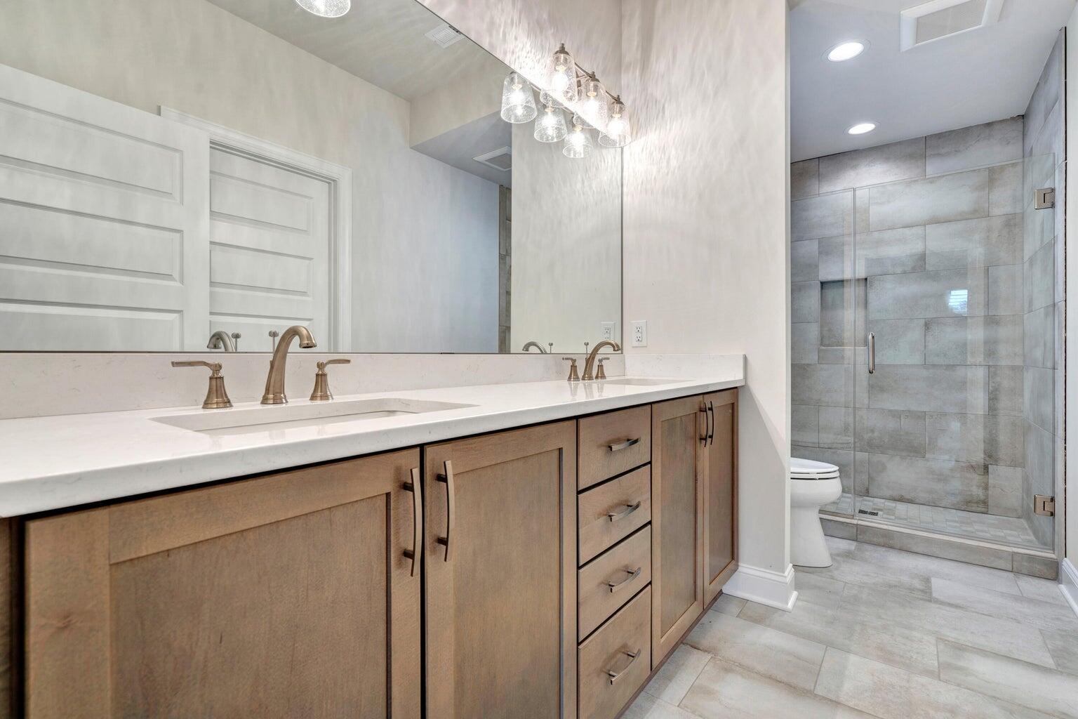 562 Dillard Road Southwest Roanoke, VA 24014 - Photo 7 of 13 a bathroom with a double vanity sink mirror double shower and a toilet