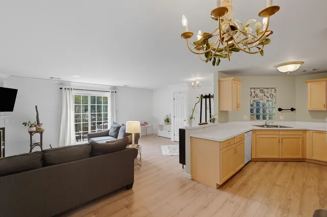 a living room with kitchen island furniture and a wooden floor