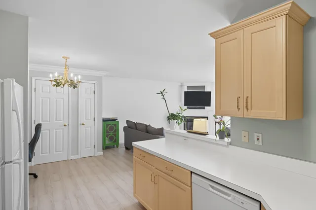 a kitchen with stainless steel appliances a refrigerator sink and microwave