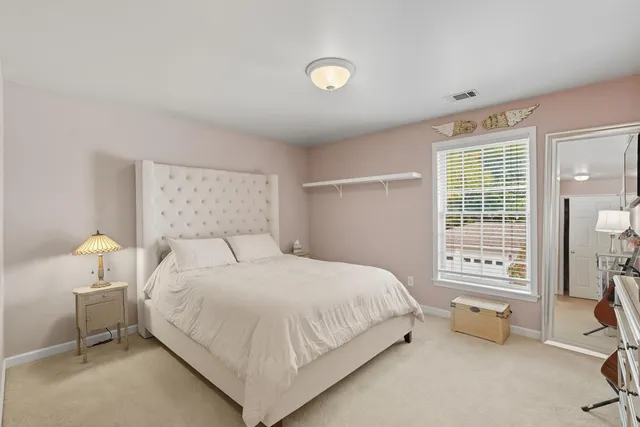 a bedroom with a bed and a night stand