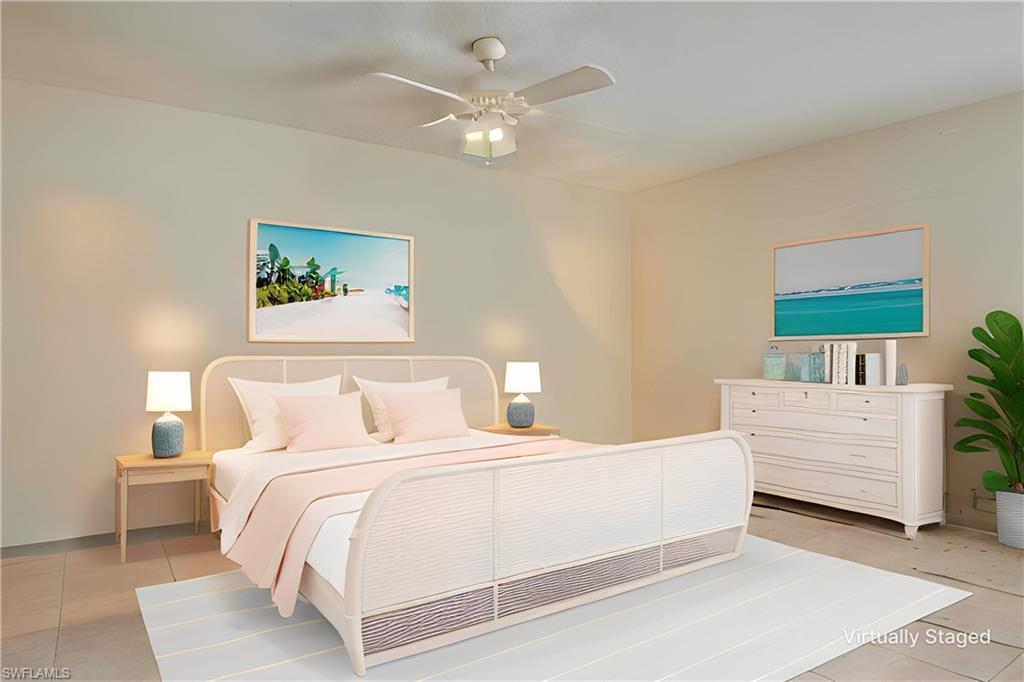 3030 Binnacle Drive, Unit 305 Naples, FL 34103 - Photo 15 of 25 a bedroom with a large bed and a chandelier