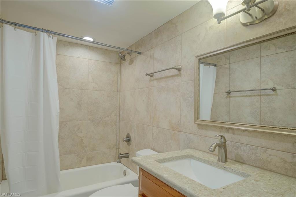 3030 Binnacle Drive, Unit 305 Naples, FL 34103 - Photo 24 of 25 a bathroom with a sink and a mirror