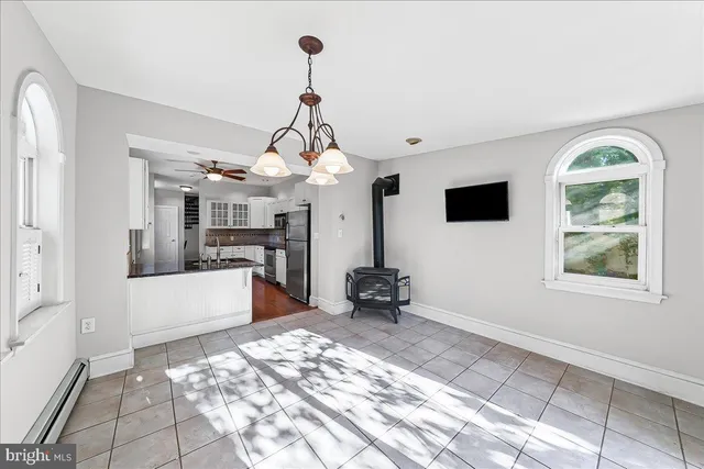 a view of a room with wooden floor and windows