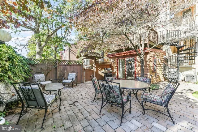 a view of a chairs and table in backyard